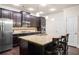 Bright kitchen featuring dark cabinets, stainless steel appliances, granite countertops, and a center island with bar stool seating at 2844 Bluestone Sw Dr, Atlanta, GA 30331