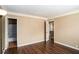 Large bedroom with wood-look floors, neutral walls, and easy access to an en-suite bathroom at 3835 Conley Downs Dr, Decatur, GA 30034
