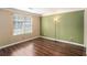 A well-lit bedroom with wood-look floors, neutral walls, and a window for ample natural light at 3835 Conley Downs Dr, Decatur, GA 30034