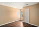Cozy bedroom features neutral paint, wood-look floors and plenty of natural light from a nearby window at 3835 Conley Downs Dr, Decatur, GA 30034