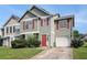 Inviting two-story townhouse featuring red shutters, a red door, and a one-car garage at 3835 Conley Downs Dr, Decatur, GA 30034