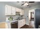 Well-lit kitchen with stainless steel appliances, granite counters and white cabinets at 3835 Conley Downs Dr, Decatur, GA 30034