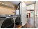 Convenient laundry room featuring modern appliances and storage shelving near the living area at 3835 Conley Downs Dr, Decatur, GA 30034