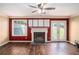 Cozy living room with a fireplace, wood floors, neutral walls, and natural light at 3835 Conley Downs Dr, Decatur, GA 30034