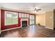 Cozy living room with a fireplace, wood floors, neutral walls, and natural light at 3835 Conley Downs Dr, Decatur, GA 30034