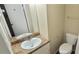 Functional bathroom featuring a standard toilet, vanity with sink, and chrome fixtures at 5595 Marbut Rd, Lithonia, GA 30058
