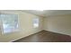 Bedroom featuring hardwood floors and natural lighting from two windows at 5595 Marbut Rd, Lithonia, GA 30058