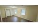 Spacious bedroom with wood-look flooring, two windows, and closet space at 5595 Marbut Rd, Lithonia, GA 30058
