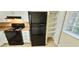 Kitchen view with an electric range, black refrigerator, and shelved closet space at 5595 Marbut Rd, Lithonia, GA 30058