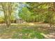 Landscaped backyard featuring storage shed and mature trees at 179 Glynn Addy Dr, Stockbridge, GA 30281