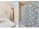 Bathroom featuring shower with decorative curtain, with view to open closet at 179 Glynn Addy Dr, Stockbridge, GA 30281