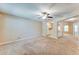 Open-concept living room features neutral walls, a ceiling fan, and seamless transition to the kitchen at 179 Glynn Addy Dr, Stockbridge, GA 30281