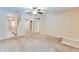 Spacious living room with a ceiling fan and seamless flow into the adjoining kitchen and hallway at 179 Glynn Addy Dr, Stockbridge, GA 30281