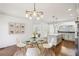 Cozy dining room with a glass table and modern chandelier next to a view of the kitchen at 2108 Main Nw St, Atlanta, GA 30318