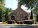 Community clubhouse featuring stone accents and landscaped grounds; visitor parking available at 3898 High Dove Sw Way # 12, Smyrna, GA 30082