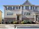 Charming two-story townhome with gray siding, brick accents, black shutters, and manicured landscaping at 3898 High Dove Sw Way # 12, Smyrna, GA 30082