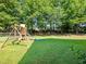 Large backyard with playground set, mature trees and shade at 443 Rhett Dr, Loganville, GA 30052