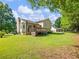 Expansive backyard showcasing a deck, a bay window, a green lawn, and the exterior of a beautiful two-story home at 443 Rhett Dr, Loganville, GA 30052