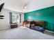 Well lit carpeted bedroom with a gray accent wall and two toddler beds at 443 Rhett Dr, Loganville, GA 30052
