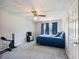 Carpeted bedroom with ceiling fan, a blue bed, and a window providing natural light at 443 Rhett Dr, Loganville, GA 30052