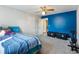 Spacious carpeted bedroom featuring a ceiling fan, and blue accent wall at 443 Rhett Dr, Loganville, GA 30052