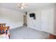 Carpeted bedroom with a ceiling fan and TV mounted to the wall at 443 Rhett Dr, Loganville, GA 30052