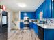 Modern kitchen featuring blue cabinets, stainless steel appliances, and hardwood floors at 443 Rhett Dr, Loganville, GA 30052