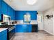 Bright kitchen with blue cabinets, stainless steel appliances, and hardwood floors at 443 Rhett Dr, Loganville, GA 30052