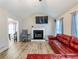 Cozy living room with fireplace, vaulted ceiling, and lots of natural light at 443 Rhett Dr, Loganville, GA 30052