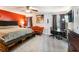Spacious main bedroom boasts an orange accent wall, a ceiling fan, and a seating area at 443 Rhett Dr, Loganville, GA 30052