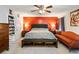 This is a spacious main bedroom with a ceiling fan, orange accent wall, and ample closet space at 443 Rhett Dr, Loganville, GA 30052