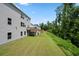 Exterior view of a home with a grassy backyard and a wooden deck at 865 Athena Bnd, Fairburn, GA 30213