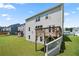Exterior featuring a home's backyard with a wooden deck and green lawn at 865 Athena Bnd, Fairburn, GA 30213