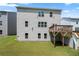 Home exterior featuring backyard with a wooden deck and a grassy area at 865 Athena Bnd, Fairburn, GA 30213