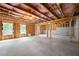 Spacious unfinished basement with insulation, wood framing, and natural light from basement windows at 865 Athena Bnd, Fairburn, GA 30213