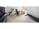 The basement features gym equipment including weights, bench and exercise machine at 865 Athena Bnd, Fairburn, GA 30213