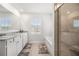 Bathroom featuring a double sink vanity, soaking tub, and glass enclosed shower at 865 Athena Bnd, Fairburn, GA 30213