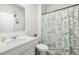 Clean bathroom with a white vanity and toilet, and a shower with a patterned curtain at 865 Athena Bnd, Fairburn, GA 30213
