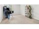 Carpeted game room featuring an arcade machine, gaming chair, and decorative shelving at 865 Athena Bnd, Fairburn, GA 30213