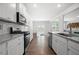 Bright kitchen features white cabinets, stainless steel appliances, granite counters, and tile backsplash at 865 Athena Bnd, Fairburn, GA 30213