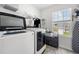 Modern laundry room with stainless steel appliances, custom storage, and natural light at 865 Athena Bnd, Fairburn, GA 30213