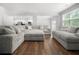 Bright living room featuring hardwood floors, comfortable seating, open floor plan, and modern decor at 865 Athena Bnd, Fairburn, GA 30213