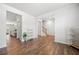 Bright living room with hardwood floors, neutral decor, open floor plan, and views of the kitchen and stairway at 865 Athena Bnd, Fairburn, GA 30213