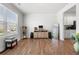 Bright living room with hardwood floors, neutral decor, and large windows offering lots of natural light at 865 Athena Bnd, Fairburn, GA 30213