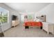 Spacious main bedroom with neutral walls and carpet, featuring two dressers below the window at 865 Athena Bnd, Fairburn, GA 30213