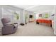 Bright main bedroom with carpeting, a recliner, and two dressers below the window at 865 Athena Bnd, Fairburn, GA 30213