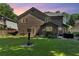 Back exterior view with grill, outdoor seating, and well-maintained lawn, perfect for relaxation at 1481 Howard Way, Lawrenceville, GA 30043