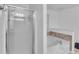 Bathroom showcasing a glass-enclosed shower and a separate soaking tub with tiled surround at 1481 Howard Way, Lawrenceville, GA 30043