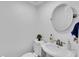 Cozy bathroom featuring a sink, toilet, mirror, and neutral paint at 1481 Howard Way, Lawrenceville, GA 30043