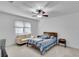 Bright bedroom with neutral carpet, a queen sized bed and a couch at 1481 Howard Way, Lawrenceville, GA 30043